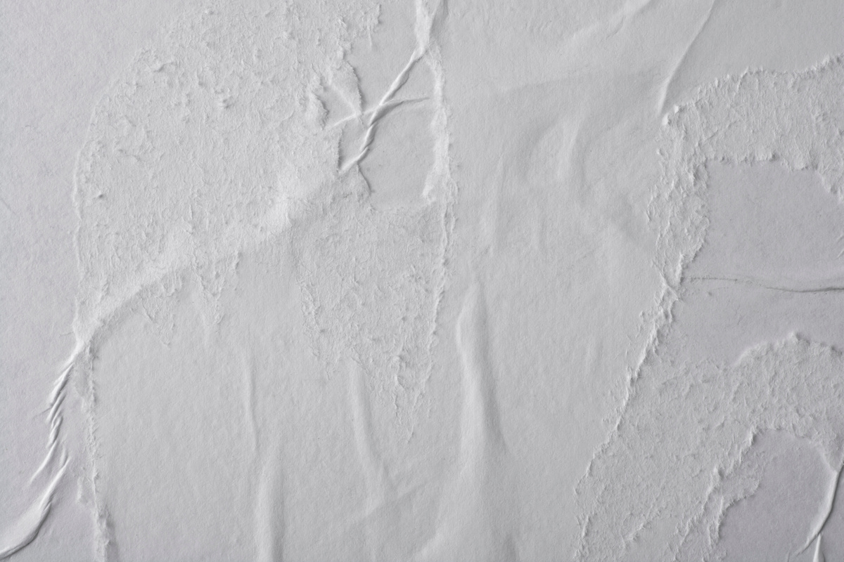 Crumpled white paper. Blank street poster texture.